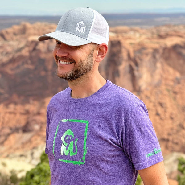 Close-up view of a man wearing the Iconic Monkee Graphic Tee while hiking