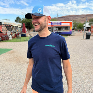 Front view of a man at a food truck park wearing the Mountain Sunrise Graphic Tee