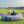 Father and son sitting in a gray camo Chill Monkee inflatable lounger at a baseball game