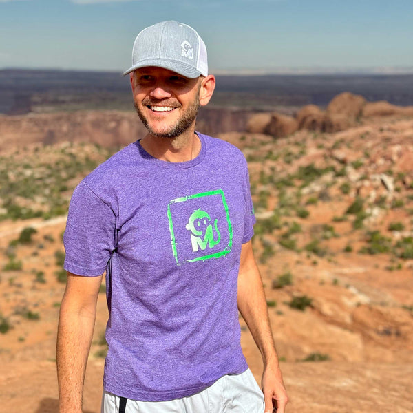 Front view of a man wearing the Iconic Monkee Graphic Tee while hiking