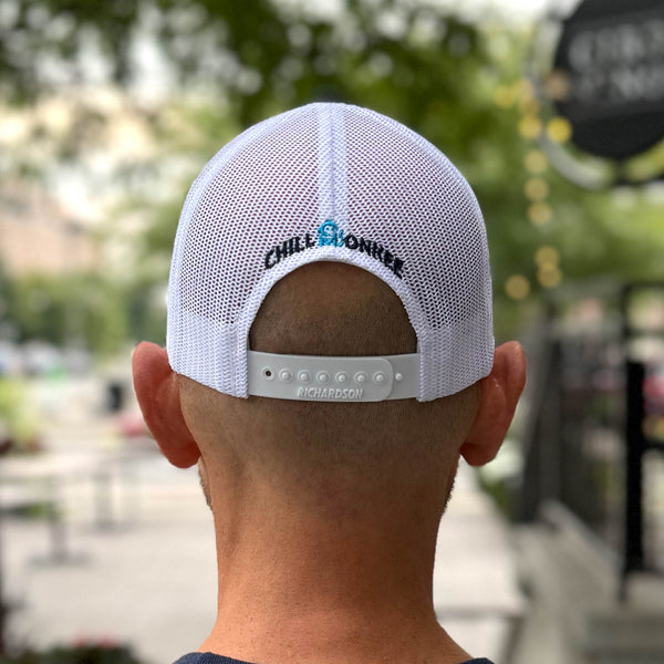 Rear view of a man wearing the Iconic Monkee Mid Pro Trucker Hat in Columbia blue, white, and navy