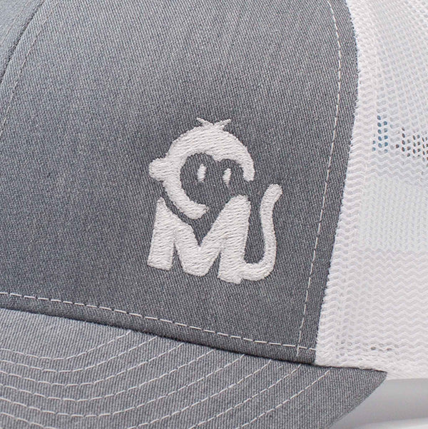 Close-up view of the Iconic Monkee Mid Pro Trucker Hat in heather grey and white