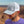 Front view of a man wearing the Iconic Monkee Mid Pro Trucker Hat in heather grey and white while hiking