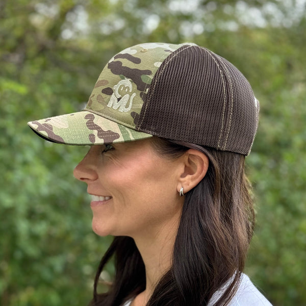 Side view of a woman wearing the Iconic Monkee Multicam Trucker Hat in original and coyote brown