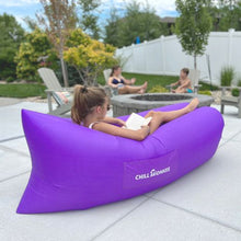 Load image into Gallery viewer, Young girl reading next to a fire pit in a purple Chill Monkee inflatable lounger
