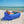 Man relaxing on a beach in a royal blue Chill Monkee inflatable lounger